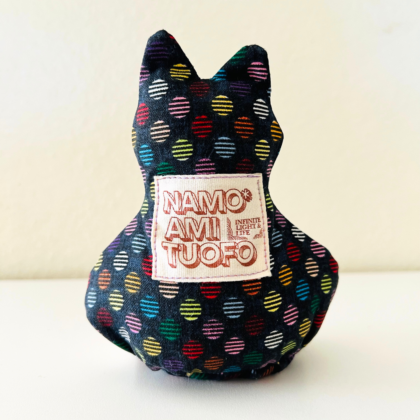 Back of Luna Paws Otedama with colorful fabric and Namo Amituofo label