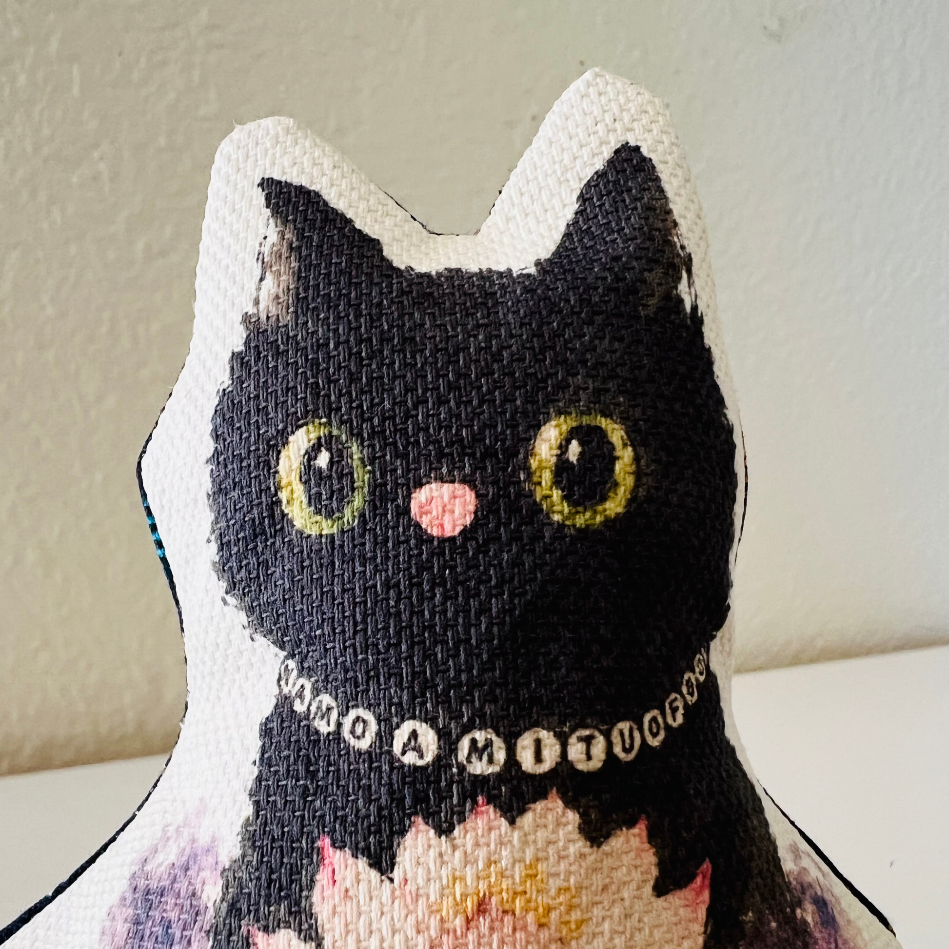 Close-up of Luna Paws black cat face and Namo Amituofo necklace
