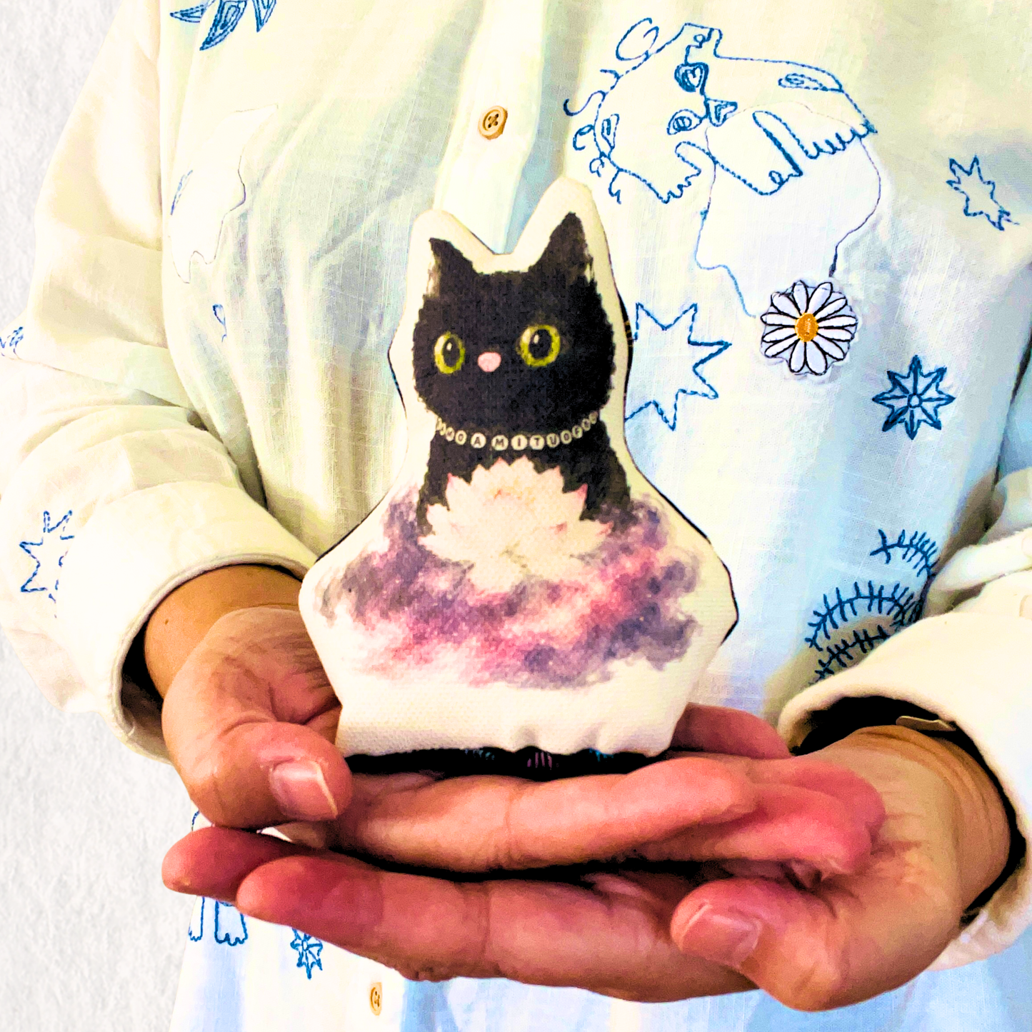 Handmade Luna Paws Otedama art doll resting in the maker's hands